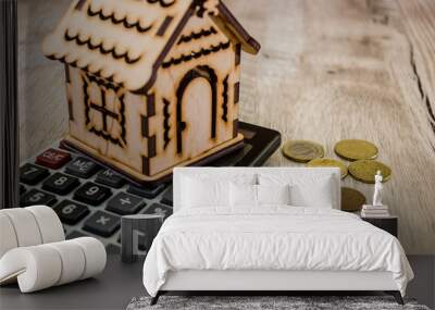 wooden, toy house on the calculator and coins Wall mural