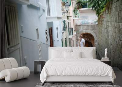 Young romantic couple on a small street in Sorrento, Italy - travel destination Wall mural