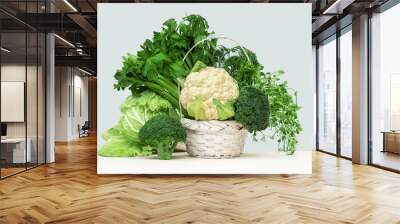 Fresh green vegetables in a basket on a wooden table. Banner with copy space. Green vegetarian diet or cuisine. Broccoli cabbage and celery. Grocery delivery or shopping online. Green diet Wall mural