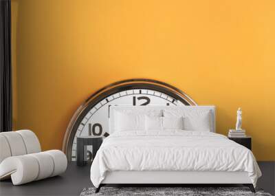 Part of analogue plain wall clock on trendy pastel orange background. Ten o'clock. Close up with copy space, time management or school concept and summer or winter time change Wall mural