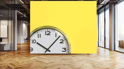 Part of analogue plain wall clock on trendy yellow background. Ten o'clock. Close up with copy space, time management or school concept and lunch time Wall mural