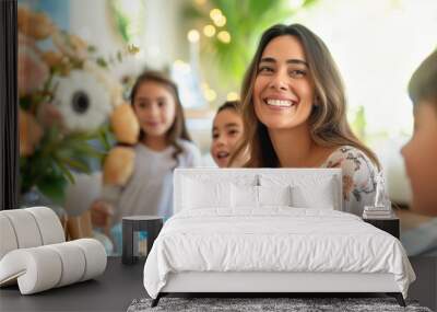 Smiling Latino woman in her 30s with three kids at home candid shot. Happy Mothers Day or birthday celebration Wall mural