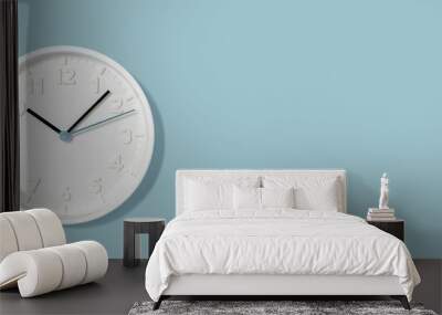 White plain analogue wall clock on trendy pastel blue background. Five past ten o'clock. Close up with copy space, time management concept and opening or closing time wide web banner Wall mural