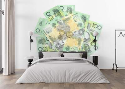 Many coins of Australian money on group of 100 dollar Australian notes pile background on white background Wall mural