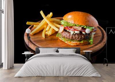 Cheeseburger with french fries on a wooden board. Wall mural