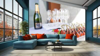 Champagne and chocolate covered strawberries served as an appetizer snack and welcome drink at an event party Wall mural