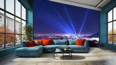 Huge spotlight rays over the night panorama of Los Angeles city Wall mural