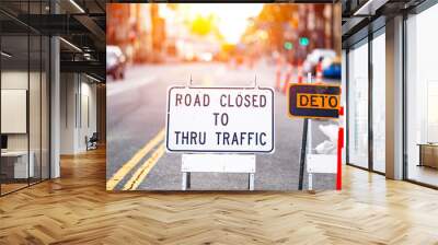 Road closed and detour sign in a road construction site work zone in the middle of a blocked street and traffic Wall mural