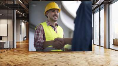 Engineer and customer shaking hands having agreement success in working site. Wall mural