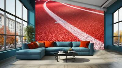 Running track with vibrant red and white lanes, soft shadows, and clear copy space for motivational sports messages. Wall mural