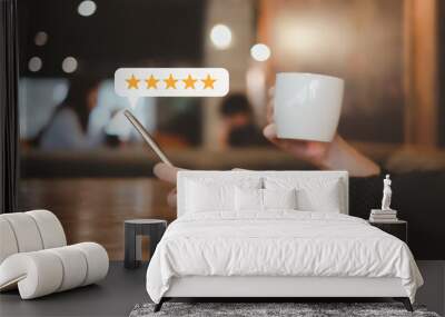 Customer hand press on smartphone screen with gold five star rating feedback icon excellent rank level for giving best score point to review the service , ranking experience, evaluate quality. Wall mural