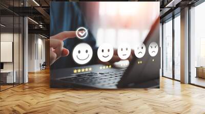 Customer satisfaction, online feedback rating and customer experience concept. User touch on virtual check mark for choosing happy smiling face with 5 star for giving best service by computer laptop. Wall mural