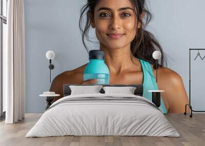 Confident Indian Woman Drinking Water in Fitness Attire Wall mural