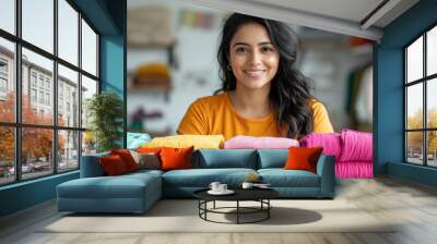 Young Indian Woman Smiling in Front of Colorful Fabrics Wall mural