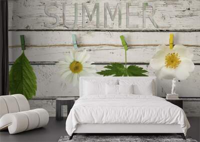 White flowers and leaves on a rope with clothespin on a wooden b Wall mural