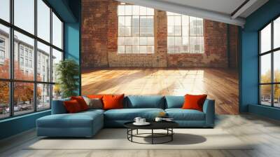 a spacious, empty studio with a wooden floor, a brick wall, and large windows that flood the room with natural light, perfect for dance or creative activities. Wall mural