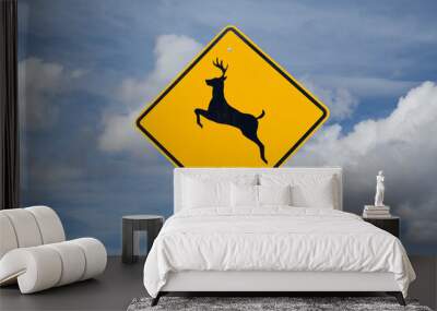 Deer crossing sign on blue sky background (North American road sign) Wall mural