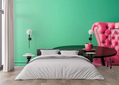 A comfortable pink leather Chesterfield armchair beside a round table with a pink coffee cup against mint green wall in a stylish, minimalistic room. Copy space. Wall mural