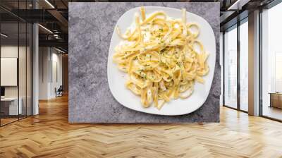 Alfredo pasta dinner with creamy white sauce and herbs Wall mural