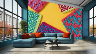 Colorful mosaic crochet texture with copy space on a yellow background. Wall mural