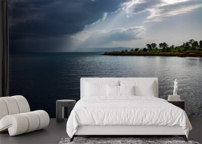 View of the Sea of Galilee or Kinneret Lake with rainy clouds and sun beams. Northern israel Wall mural