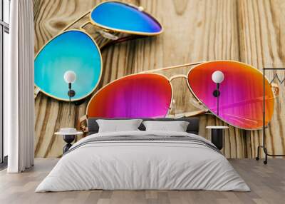 two colored sunglasses on the wooden background Wall mural