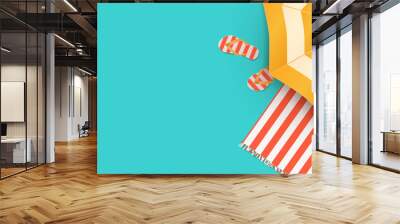 Summer beach concept. Summer holidays design template for promo poster, web banner, social media and mobile apps. Paper cut tropical beach top view background with umbrella, flip flops and beach towel Wall mural