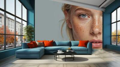 Close-up of a beautiful girl with freckles on her face Wall mural