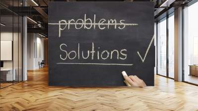 problems and solutions written on a blackboard showing a hand ho Wall mural