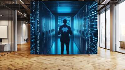 A person standing in a data center, illuminated by blue light and surrounded by digital circuitry, representing modern technology. Wall mural