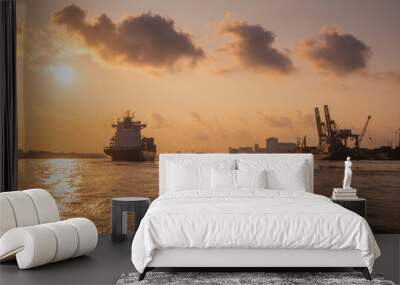 Cargo ship is sailing out of the harbor at evening to sea to transport cargo in the container.Logistics and transportation of International, Freight Transportation, Shipping Wall mural