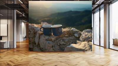 Two blue enamel coffee cups on rocky mountain top with scenic sunrise view Wall mural