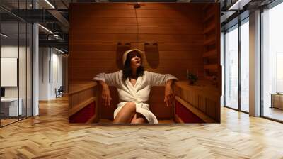 Young woman in the infrared sauna during a procedure at the spa resort center. Body care Wall mural