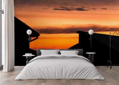 silhouette of roofs of houses on a sunset background Wall mural