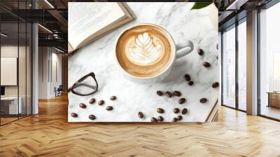 A cozy coffee break with latte art, reading glasses, and an open book on a marble table Wall mural