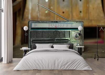 Old radio on a wooden chair. Focus selected Wall mural