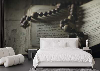 an old prayer book and wooden rosary in the dark Wall mural