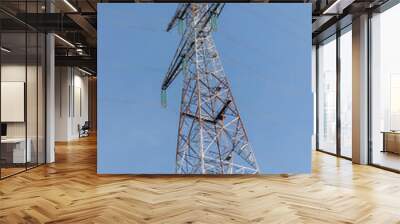 Big electricity tower, bottom-up view, with blue sky in the background Wall mural