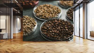 Coffee beans of various varieties are arranged in bowls on the table. Wall mural