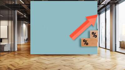 Wooden block with percentage sign and up arrow financial and business growth interest rates and mortgage rates interest on investment inflation concept on blue background. Wall mural