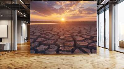 arafed cracked land with a sunset in the background Wall mural