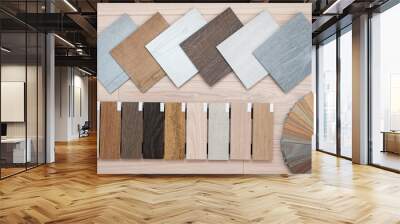 An example of a catalog of luxury vinyl floor tiles and a designer palette with textures with a new interior design for a house or floor on a light wooden background. Wall mural