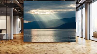 the rays of the sun passing through the clouds Wall mural