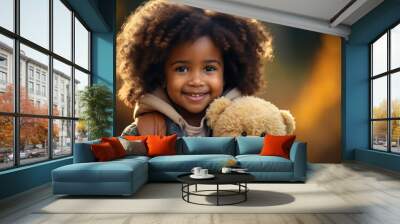 A cute little girl looks at the camera, smiles and play with toy bear Wall mural