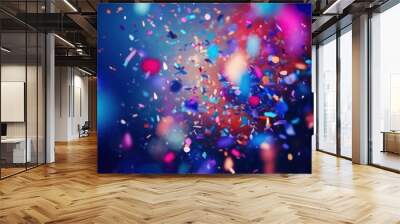 A festive and colorful party with flying neon confetti on a purple, red and blue background Wall mural