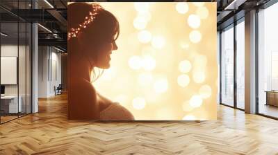 A radiant pregnant woman stands gracefully, illuminated by sparkling lights, embodying joy and anticipation for new beginnings Wall mural