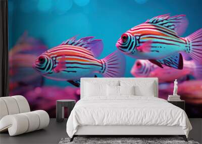 A school of ornamental fish with vivid stripe patterns swimming in a neon-lit aquarium environment, showcasing a lively underwater spectacle. Wall mural