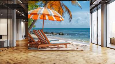 A tropical beach scene with two striped sun loungers under an orange umbrella, surrounded by palm trees and blue ocean. Wall mural