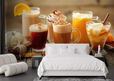 A variety of fall-themed beverages, including hot and cold drinks, displayed on a rustic wooden table with autumn decor. Wall mural