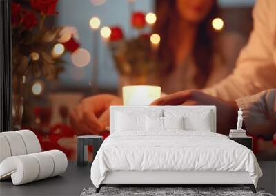 Blurred image of a couple at a candlelit dinner, holding hands with red roses on the table. Wall mural